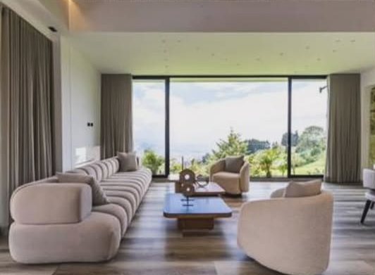 Sala con sofás curvos y vista al valle
