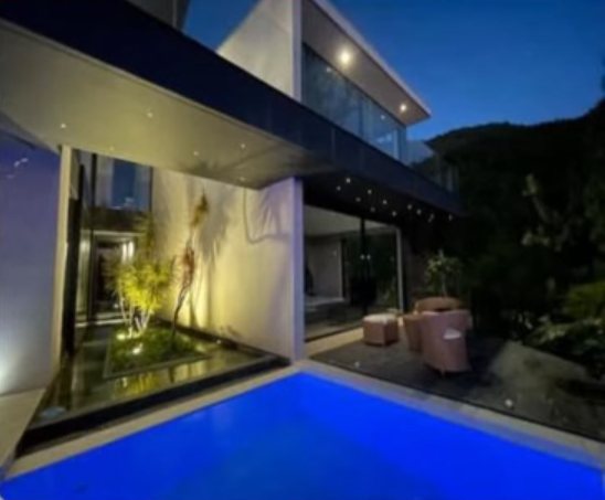 Patio interior con jardín y piscina azul de noche
